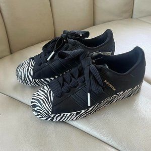 Black leather Adidas Superstars with zebra detailing